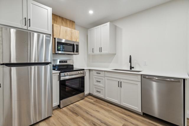 Kitchen with stone countertops and stainless steel appliances