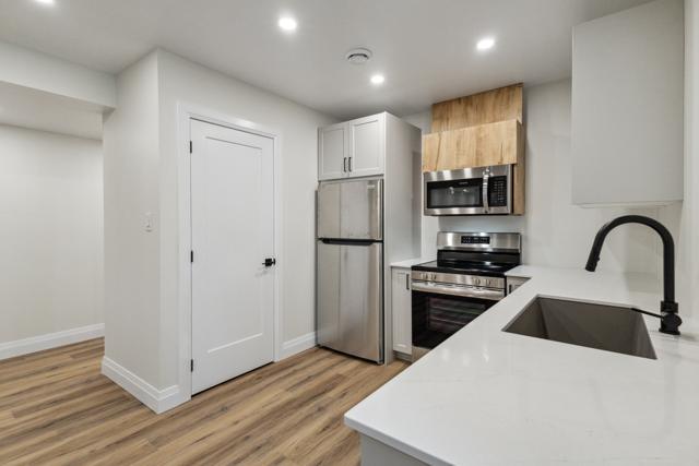 Kitchen island with stone counter and black fixtures