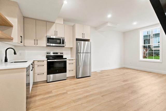 Kitchen with stainless appliances and quartz counters