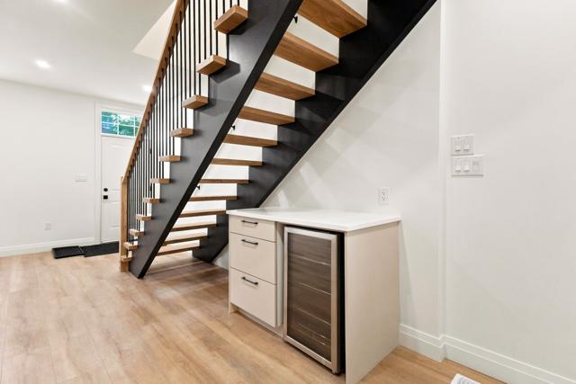 Beverage fridge and coffee bar under the stairs