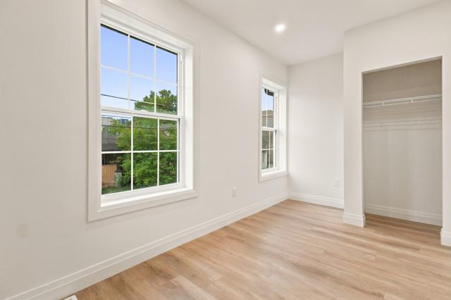 Bedroom with large window and closet