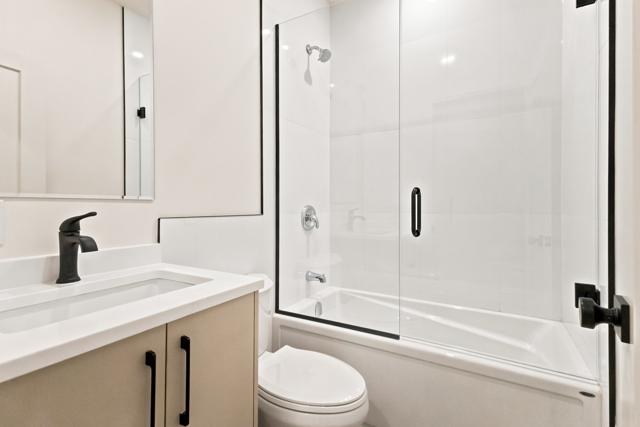 Bathroom with glass shower and black fixtures
