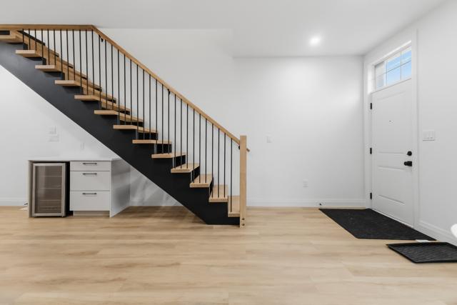 Open oak staircase with coffee bar and beverage fridge