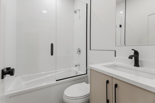Bathroom with glass shower and black fixtures